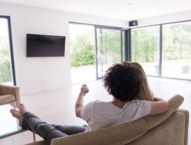 Rear view of couple watching television