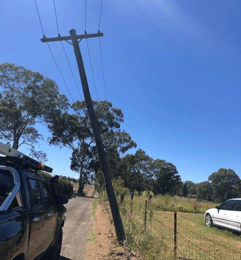 leaning-power-pole-on-farm