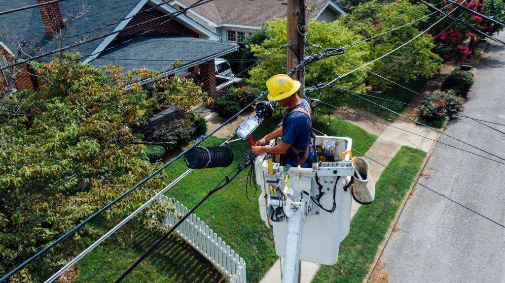 Electrician climbing on electric poles to install and repair power lines