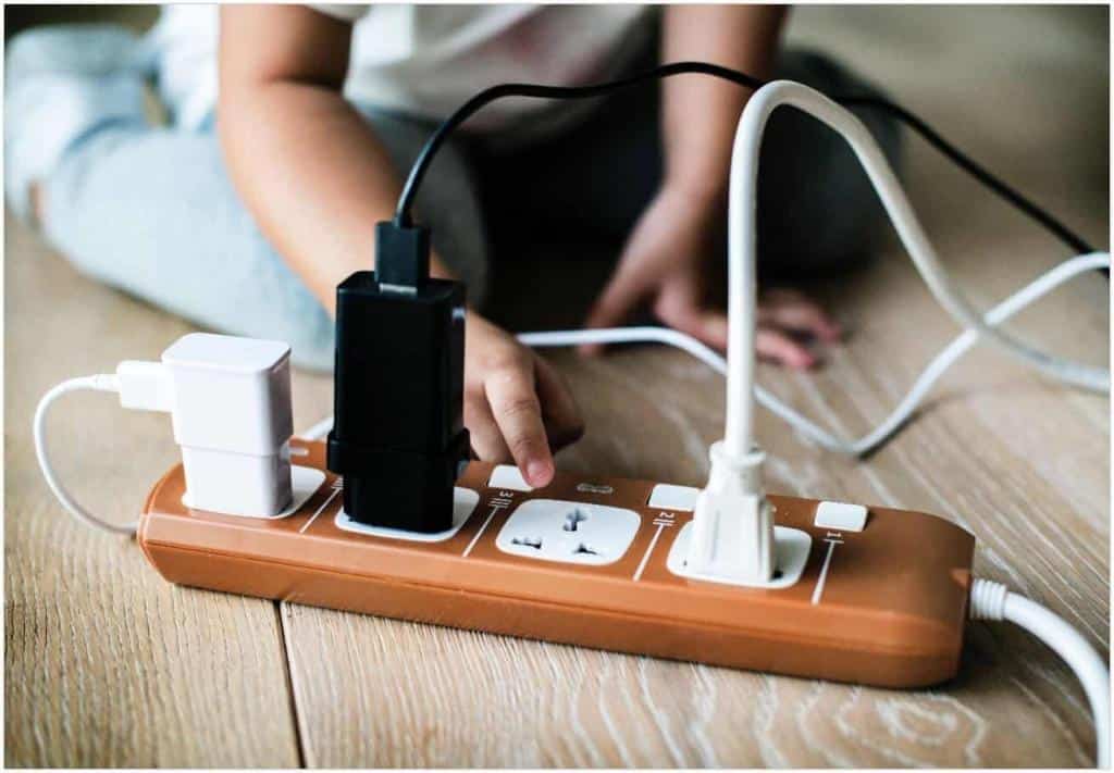 Toddler playing with plug